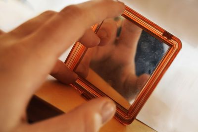 Close-up of hand holding camera