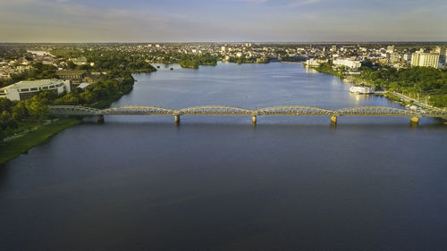 High angle view of bridge over river in city against sky