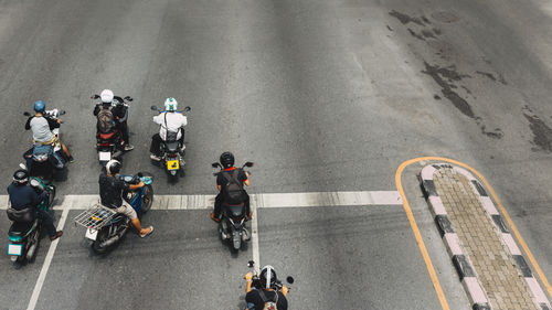 High angle view of people riding motorcycles on road