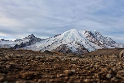 Low angle view of mountains against cloudy sky