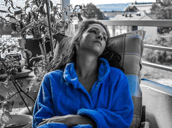 Portrait of a young woman sitting outdoors