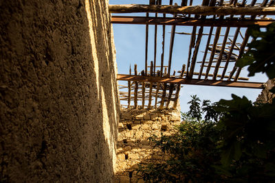 Construction site by building against sky