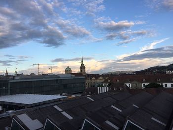 Houses against cloudy sky