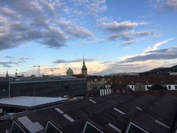 Houses against cloudy sky