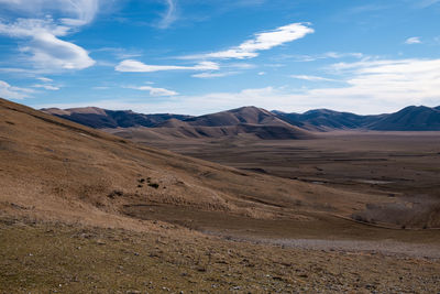 Scenic view of arid landscape against sky in umbria 