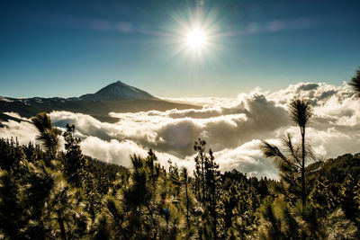 Scenic view of mountains against bright sun