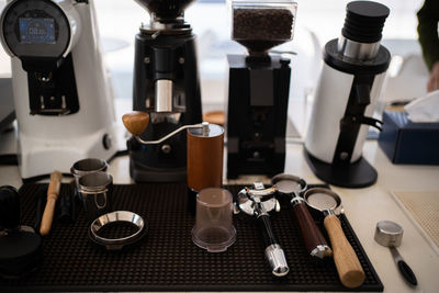 Banner of asian barista tamping the portafilter and preparing cup of coffee