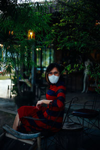 Portrait of young woman sitting on chair