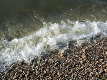 High angle view of waves reaching on shore