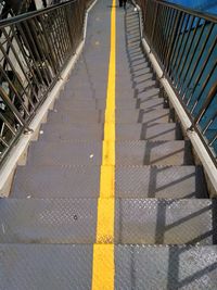 High angle view of yellow railing on staircase