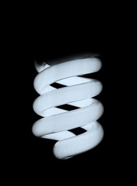 Close-up of light bulb against black background