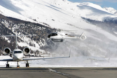 Helicopter landing at engadine st moritz airport in winter