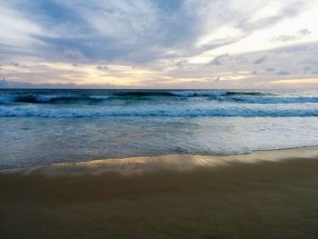 Scenic view of beach against sky during sunset