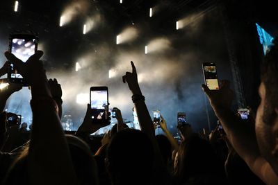 People photographing during music concert at night