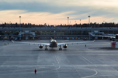 High angle view of airplane on airport runway against sky