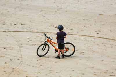 Man riding bicycle on beach