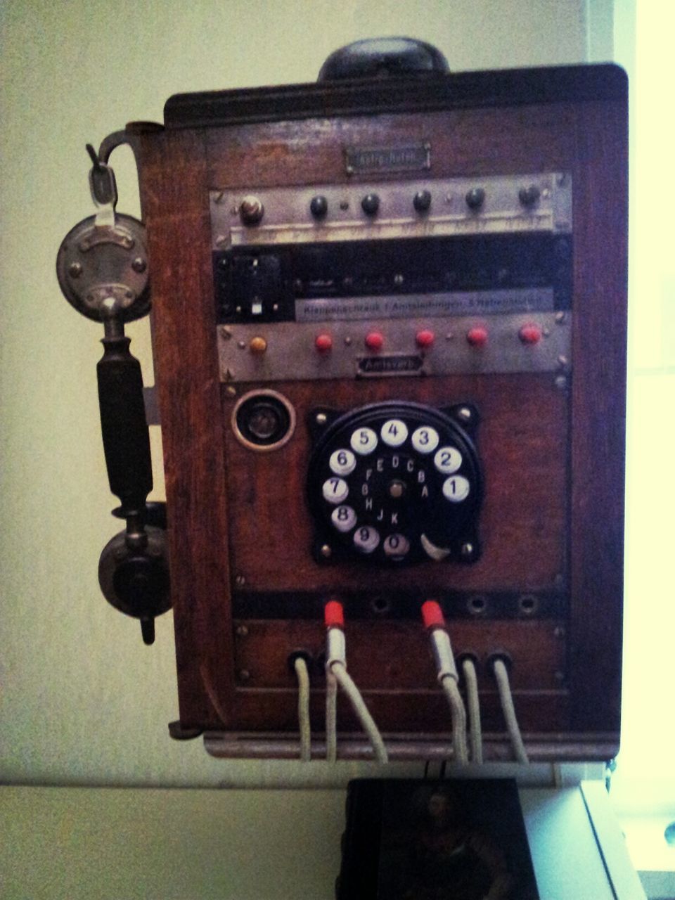 indoors, clock, old-fashioned, time, communication, retro styled, number, close-up, wall - building feature, text, technology, metal, door, antique, no people, old, human representation, low angle view, telephone, accuracy