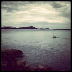 Scenic view of sea against cloudy sky