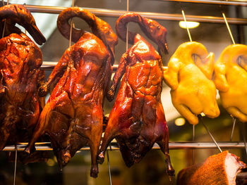 Close-up of roasted ducks hanging at market