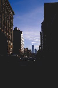 Road amidst buildings against sky in city