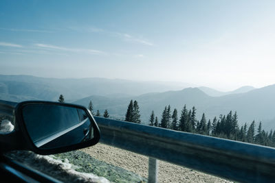 Car on mountain landscape against sky