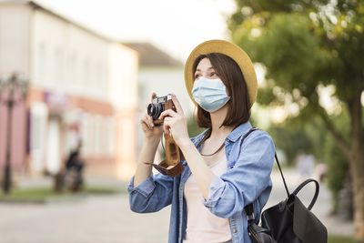 Portrait of woman photographing