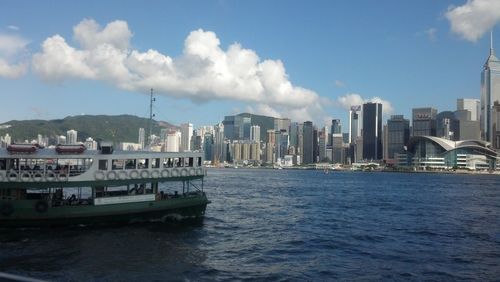 View of city by sea against sky