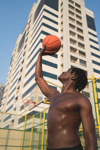 Low angle view of man playing with ball