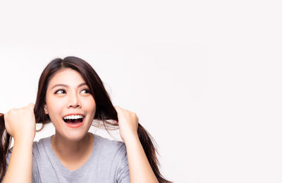 Portrait of young woman against white background