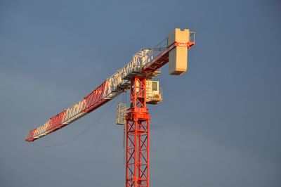 Low angle view of crane against clear sky