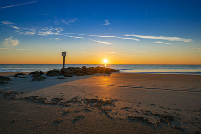 Scenic view of beach against sky during sunset