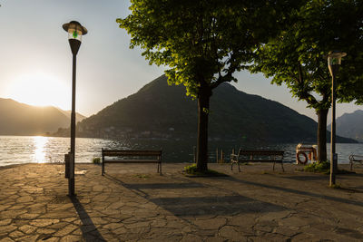 Street by lake against sky