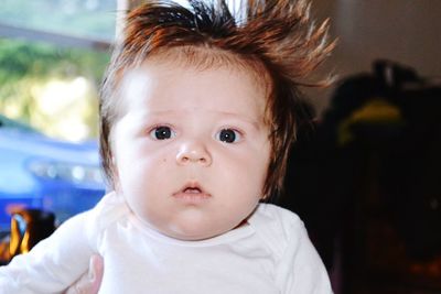 Close-up portrait of cute baby boy at home