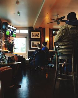 Rear view of man sitting on chair