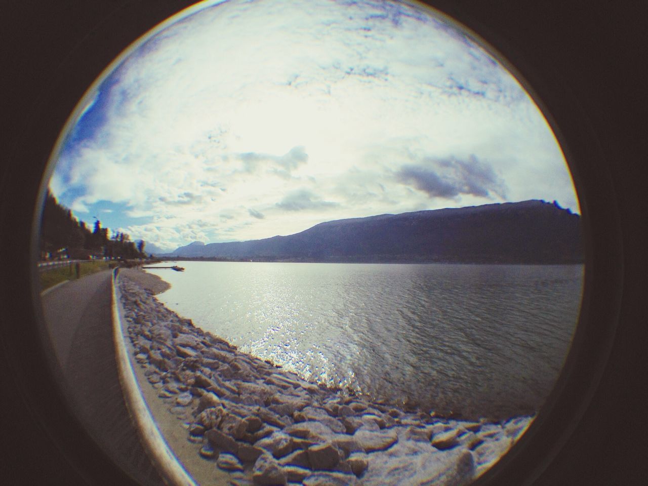 sky, water, tranquil scene, scenics, tranquility, cloud - sky, sea, beauty in nature, nature, beach, fish-eye lens, cloud, reflection, circle, idyllic, cloudy, shore, day, no people, outdoors