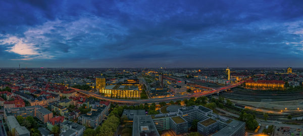 High angle view of city buildings against cloudy sky