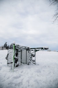 Snow covered field against sky