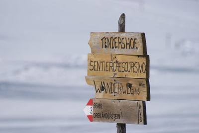Information sign on wood against sky