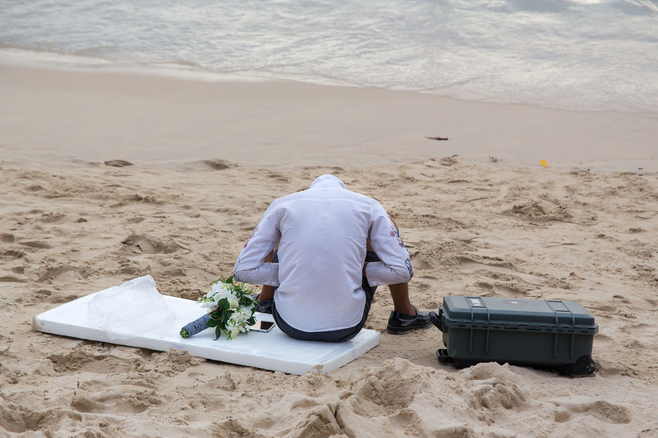 sand, beach, real people, rear view, one person, day, men, nature, outdoors, sea, lifestyles, water, beauty in nature, sand pail and shovel