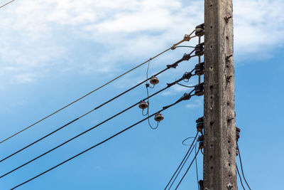 Low angle view of electricity pylon against sky