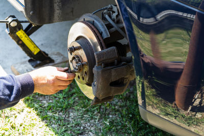 Cropped hand of man repairing car