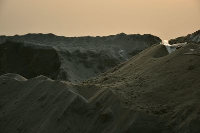 Scenic view of desert against sky during sunset