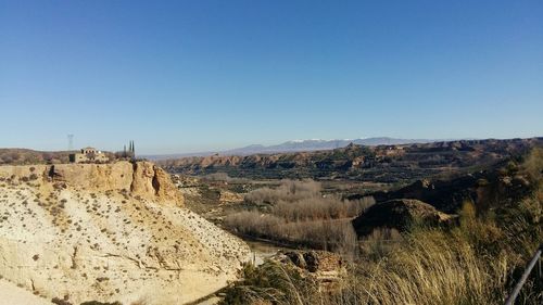 Panoramic view of landscape against clear blue sky