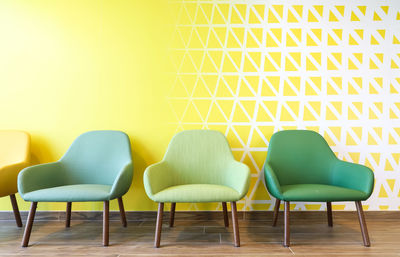 Empty chairs and table against wall at home