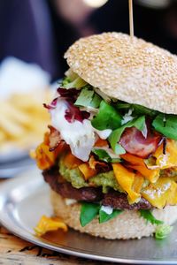 Close-up of bacon cheeseburger on plate