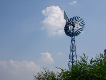 Low angle view of traditional windmill against sky