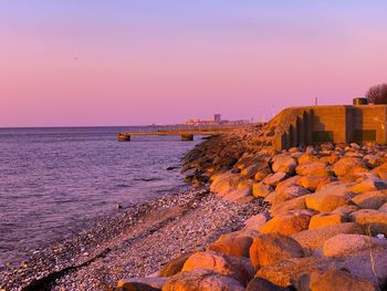 Scenic view of sea against orange sky