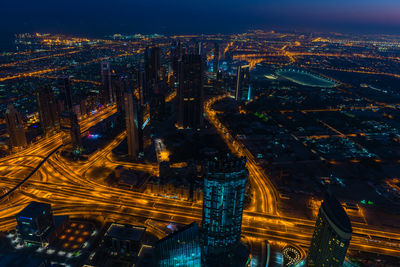 High angle view of illuminated modern buildings in city at night