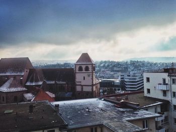 Buildings against cloudy sky