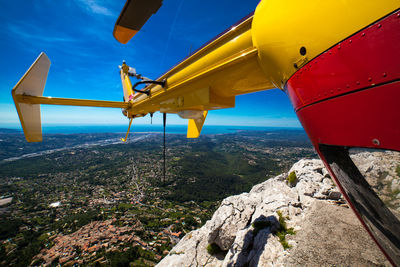 Airplane flying over landscape against sky